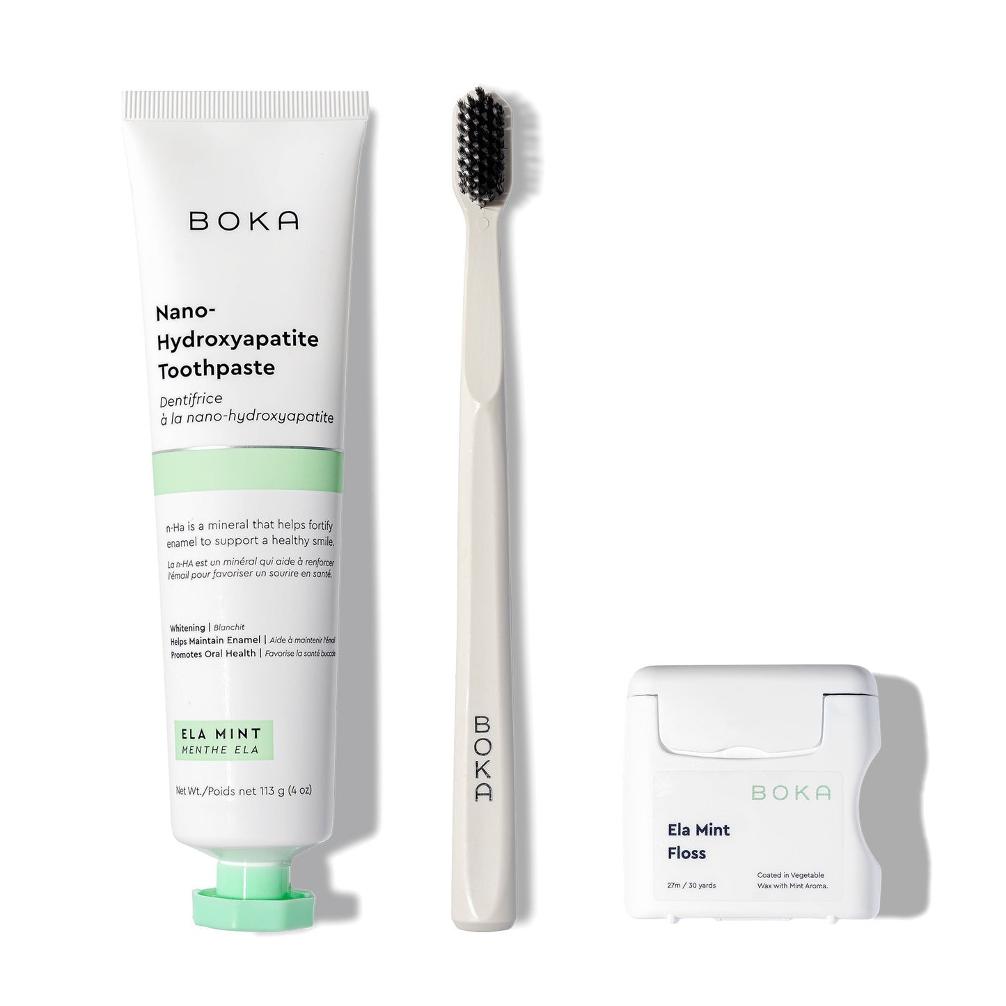 Classic Kit with Boka toothpaste, charcoal toothbrush, and Teflon-free floss on white background.