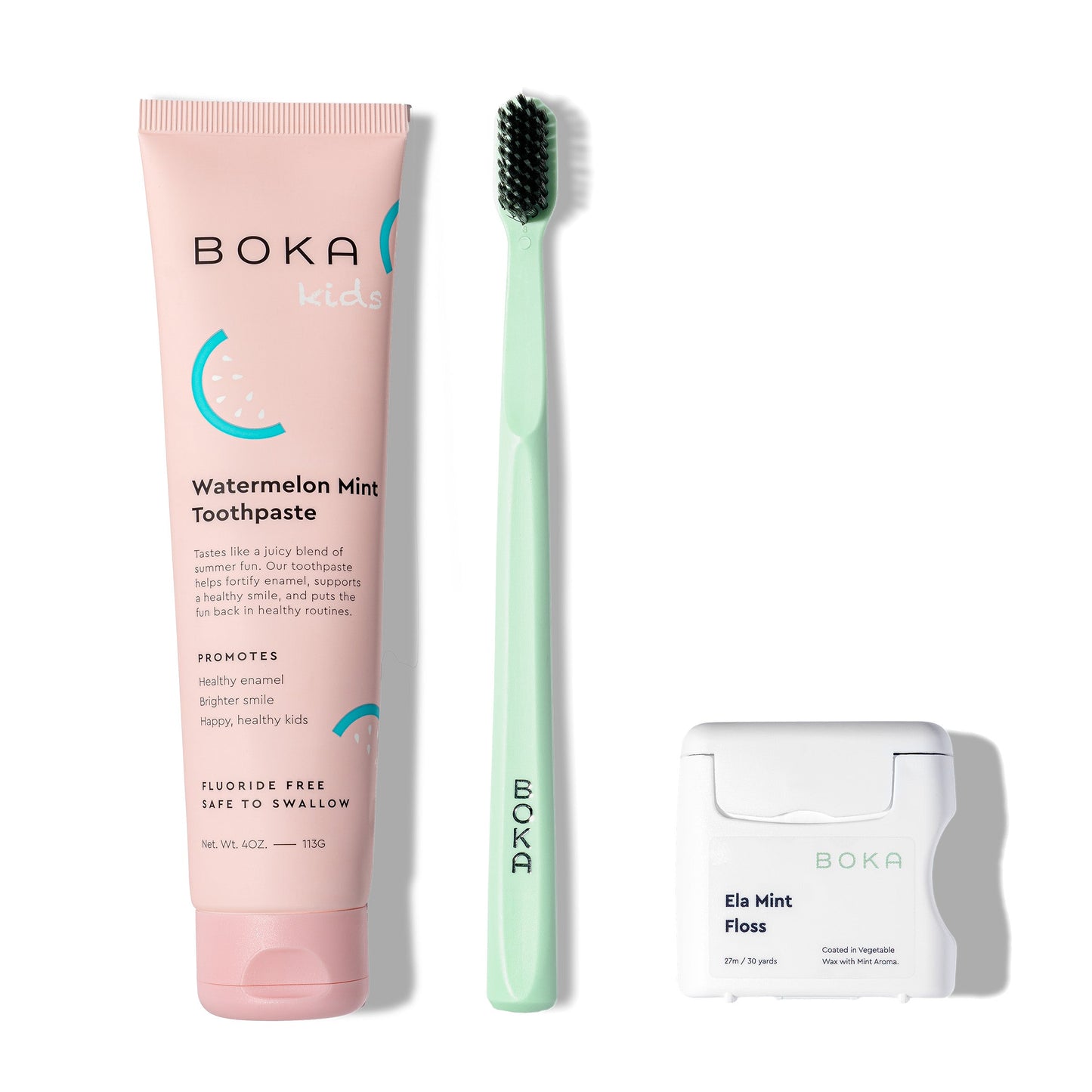 Classic Kit: pink nano-hydroxyapatite toothpaste, mint-green charcoal brush, and white floss.