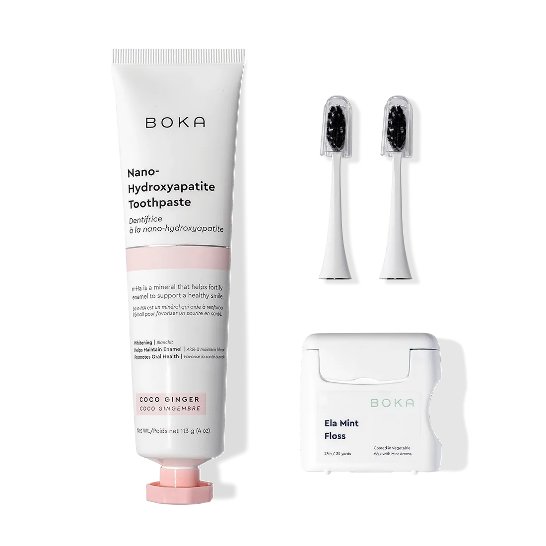 Boka Kit Refill with brush, two heads, toothpaste, and floss on a white background.
