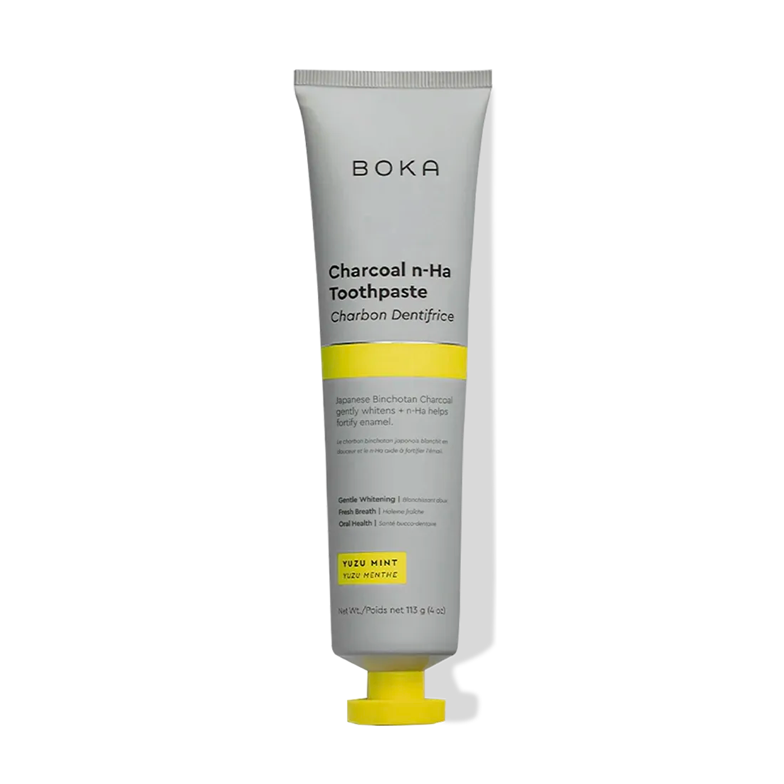 A tube of Charcoal Yuzu Mint Whitening n-Ha Toothpaste with yellow and gray labeling, upright.