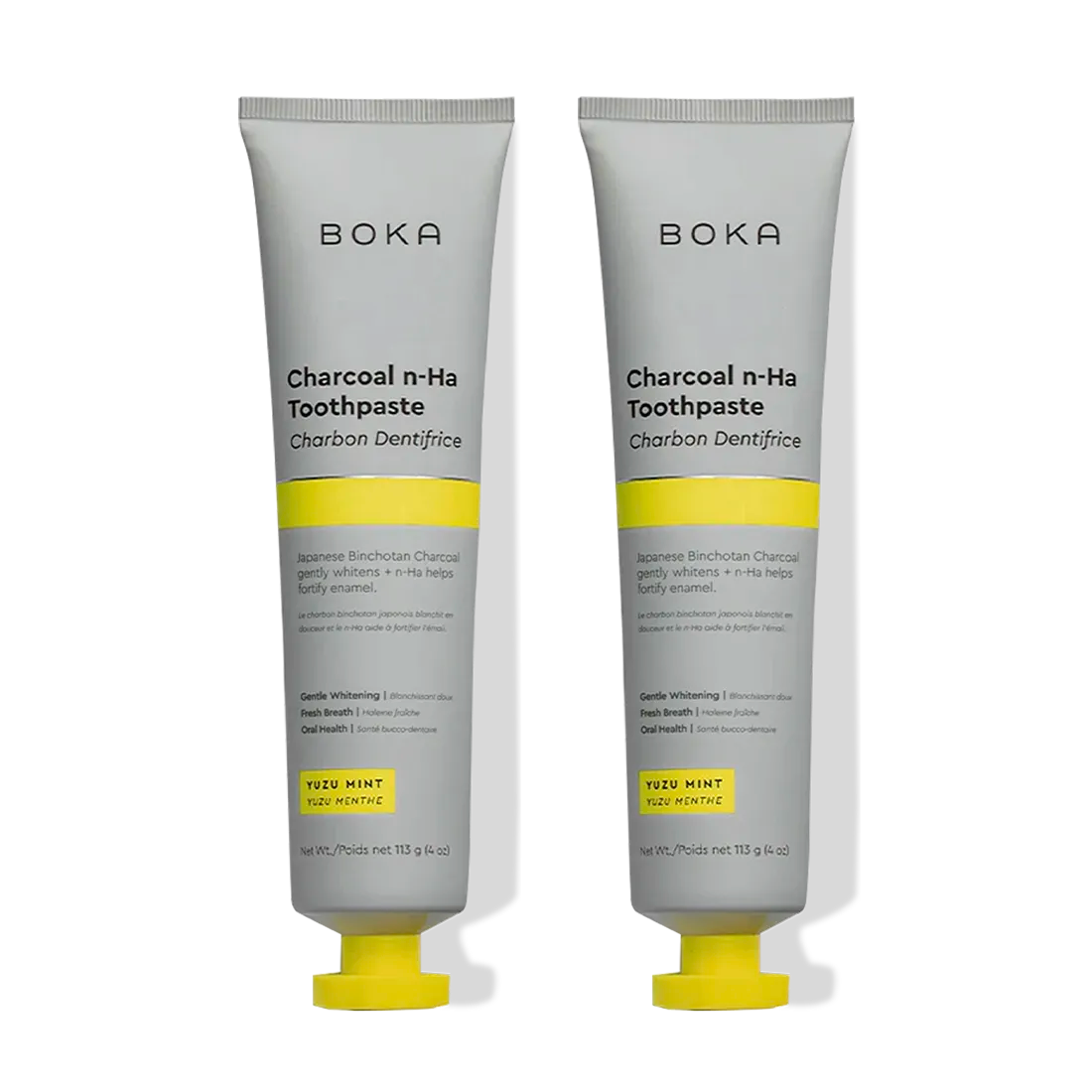 Two tubes of Charcoal Yuzu Mint Whitening n-Ha Toothpaste, standing side by side.