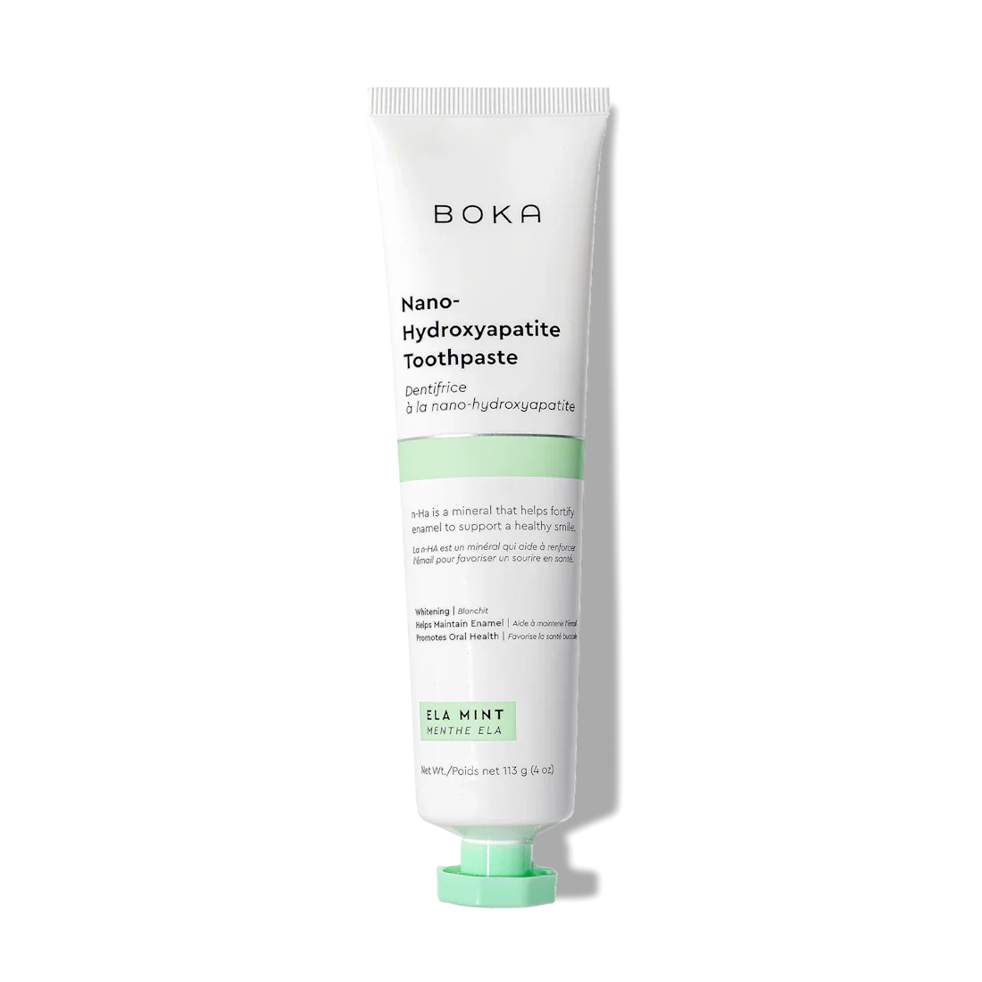 A white tube of Ela Mint n-Ha Toothpaste, fluoride-free with a green label and mint flavor.