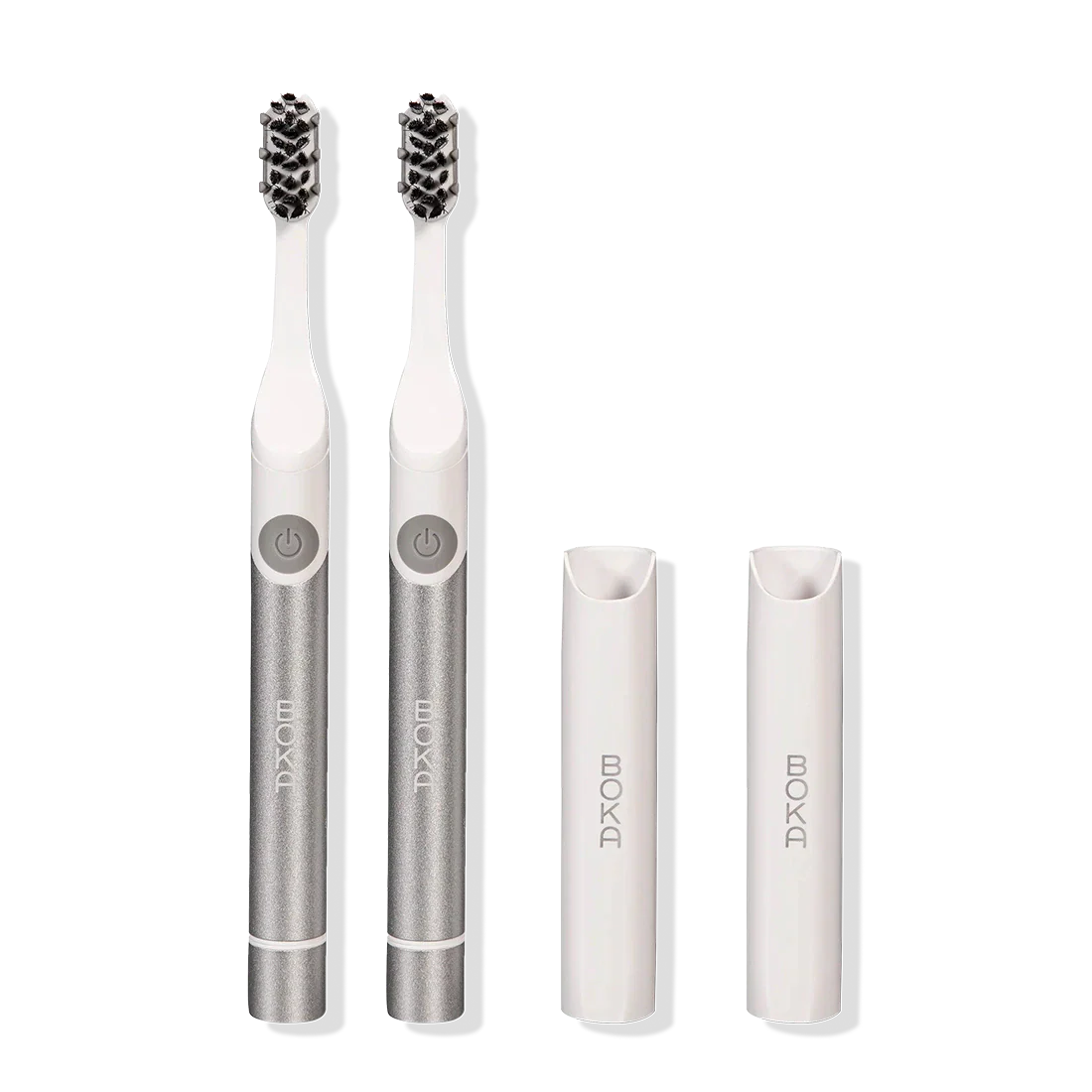 Two Boka Pocket Electric Toothbrushes with Sonic Pulse Technology and white caps on white.