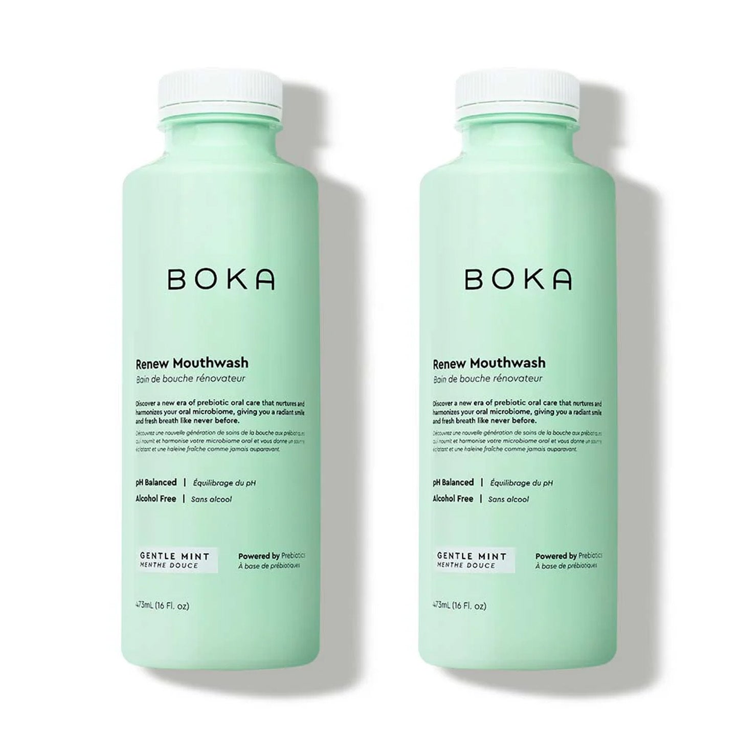 Two mint green bottles of Renew Liquid Mouthwash on a white background.