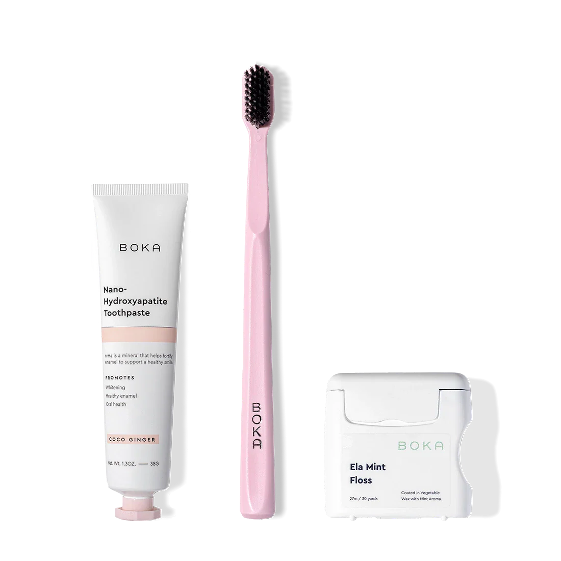 Travel Kit: Boka toothpaste, pink toothbrush with charcoal bristles, and Ela Mint Teflon-free floss.