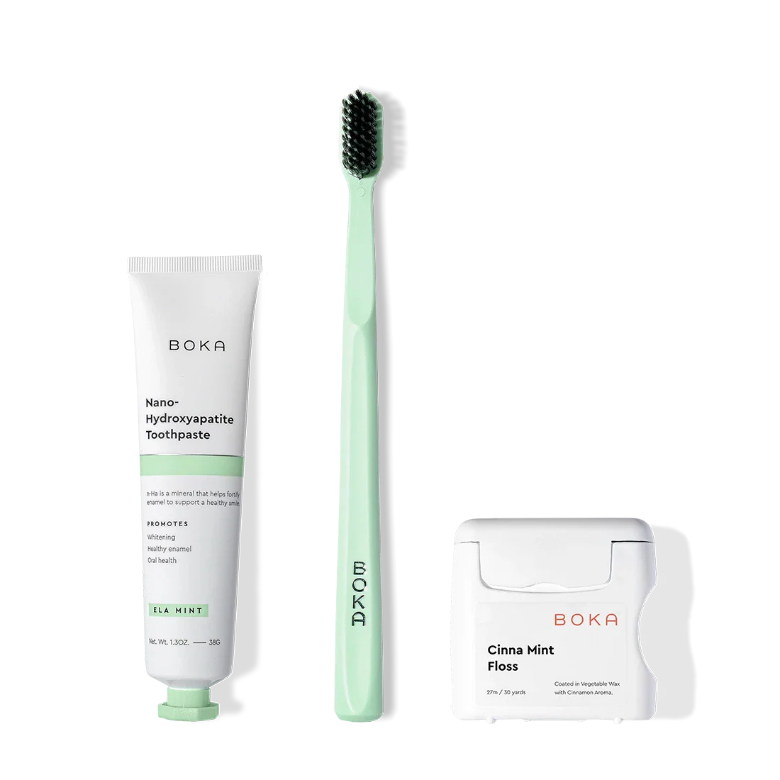 Travel Kit: green charcoal toothbrush, nHA toothpaste, and teflon-free floss on white.