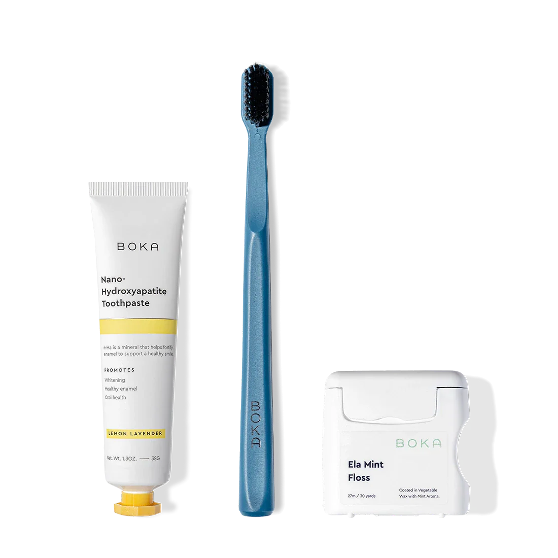 Travel Kit featuring toothpaste, blue charcoal-bristle toothbrush, and teflon-free floss on display.
