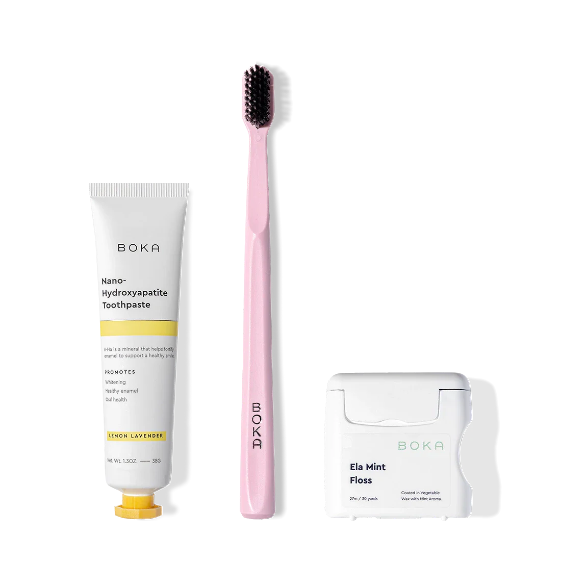 The Travel Kit includes toothpaste, an activated charcoal toothbrush, and floss side by side.