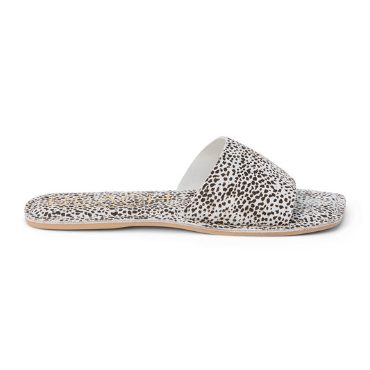 Stylish slide sandals featuring a chic white and black spotted print, perfect for casual outings with a trendy and comfortable design.