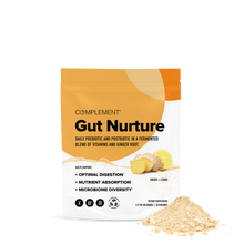 A pouch labeled COMPLEMENT® Gut Nurture by Complement features ginger root and powder images. The packaging highlights digestion support, nutrient absorption, and gut microbiome health. Some prebiotic and postbiotic powder is spilled in front.