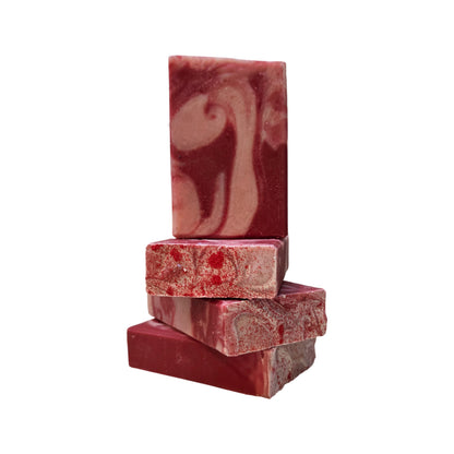 Peppermint Bar Soap by Me&T shown on a white background. This soap has jojoba beads in the red and white swirl layer