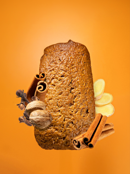 Pumpkin Spice Loaf with Ingredients (cinnamon, ginger, clove, nutmeg) on an orange background.