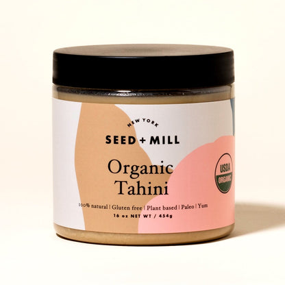 Jar of Seed + Mill Organic Tahini with a black lid on a white background