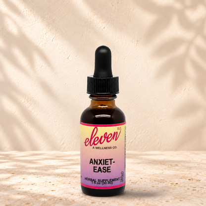 Eleven TLC Anxiet-Ease herbal tincture for calm and clarity, 1 fl oz amber dropper bottle with pink and yellow label