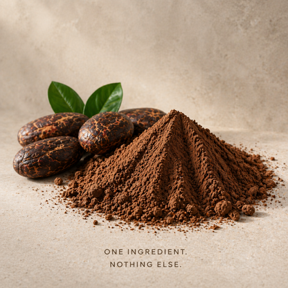 A mound of organic cacao powder beside whole cacao beans: one ingredient, nothing else.