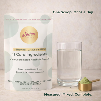 Eleven TLC Verdant Daily System pouch and metallic scoop with powder next to a glass of water on a minimalist stone surface.