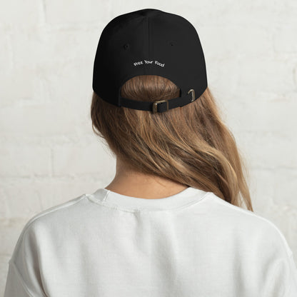 Back view of the Everyday Bare Life Cap in black worn by a model, featuring 'Free Your Food' embroidery and adjustable strap with buckle.