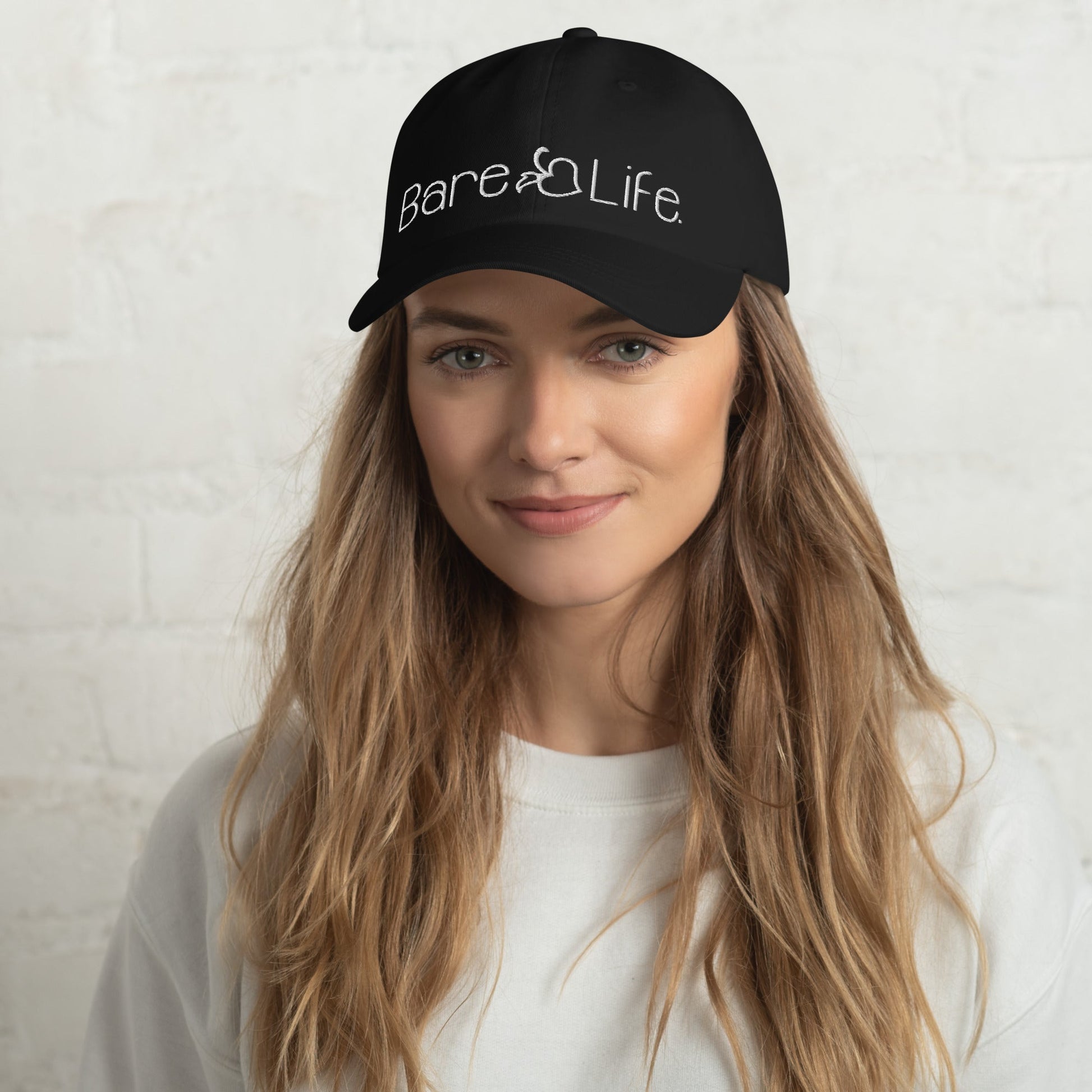 Model wearing the Everyday Bare Life Cap in black, highlighting the embroidered Bare Life logo and relaxed fit.