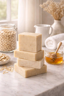 oatmeal milk and honey bar soap stack with honey and oatmeal on the counter