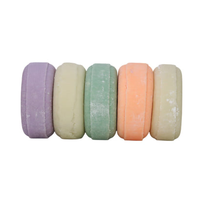 Colorful Solid Shampoo Bars stacked horizontally in purple, green, orange, and white