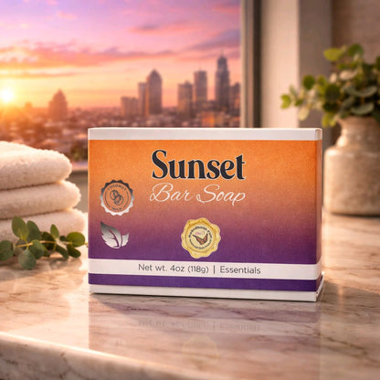 Sunset bar soap box on a tan countertop with a sunset scene in the window behind