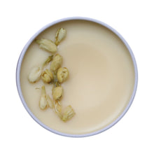 Jasmine Jive Wickless candle inside showing jasmine buds on top of white wax
